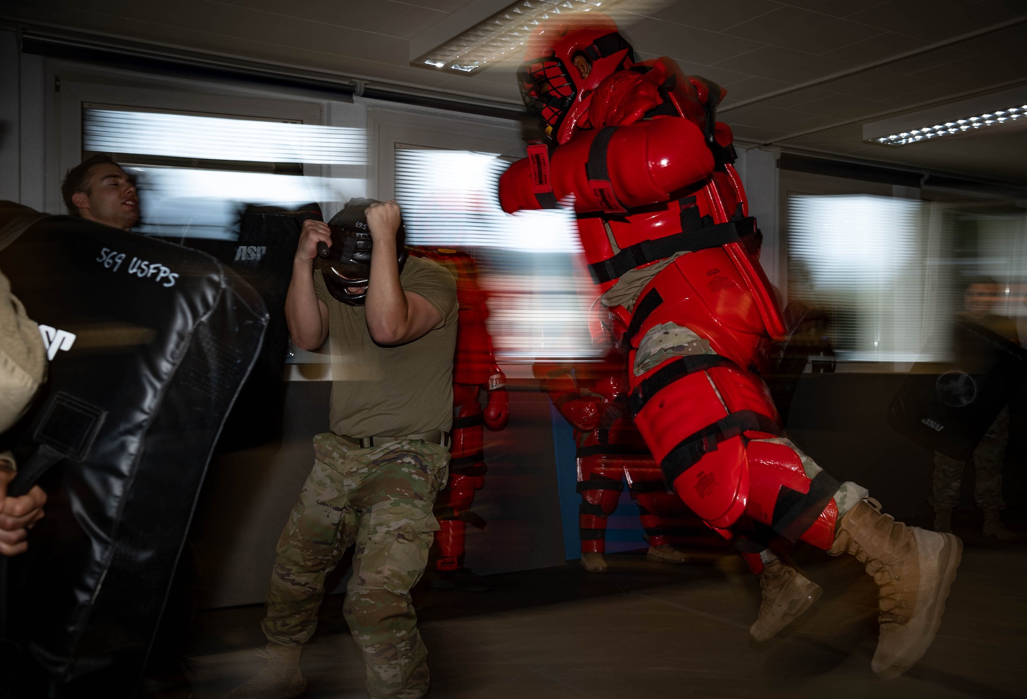 Airmen assigned to the 569th United States Forces Police Squadron, undergo Red Man training at Vogelweh Air Station, Germany, Dec. 6, 2021. Red Man training serves to prepare Airmen for a real-life physical altercation with a violent individual and build their confidence so that they respond to such a situation appropriately. (U.S. Air Force photo by Airman Jared Lovett)