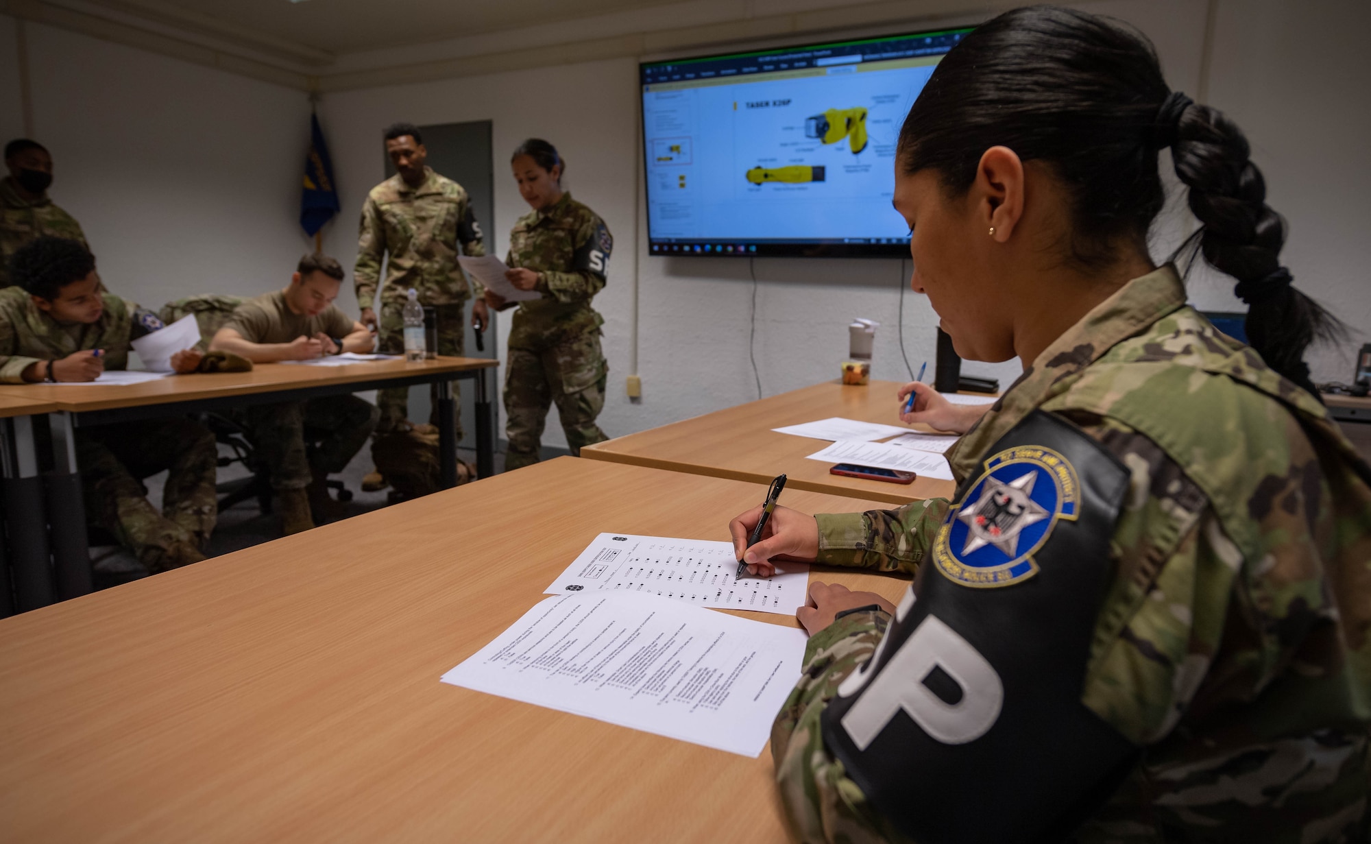 U.S. Air Force Senior Airman Ivanna Jenkins, 569th United States Forces Police Squadron patrolman, completes the Taser X26P User Certification Test at Vogelweh Air Station, Germany, Dec. 6, 2021. The test ensures that the user of the Taser X26P understands how to use the weapon safely and effectively.  (U.S. Air Force photo by Airman Jared Lovett)