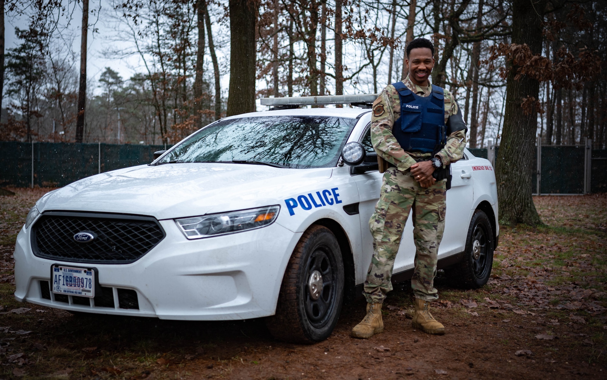 U.S. Air Force Staff Sgt. William Murray, 569th United States Forces Police Squadron unit training instructor, poses in front of a vehicle at Ramstein Air Base, Germany, Dec. 10, 2021. The 569th United States Forces Police Squadron is a U.S. Military Law Enforcement Unit that serves and protects the Kaiserslautern Military Community. (U.S. Air Force photo by Airman Jared Lovett)