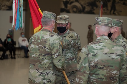 Brig. Gen. Jon M. Harrison, Director of Joint Staff, passes a guidon to Col. Thomas J. Gibson during a change of command ceremony at the Armed Forces Reserve Center in Mustang, Oklahoma, Jan. 8, 2022. The Guardsmen honored outgoing commander Col. Jason Henry and welcomed incoming commander Col. Thomas J. Gibson. (Oklahoma National Guard photo by Sgt. 1st Class Mireille Merilice-Roberts)