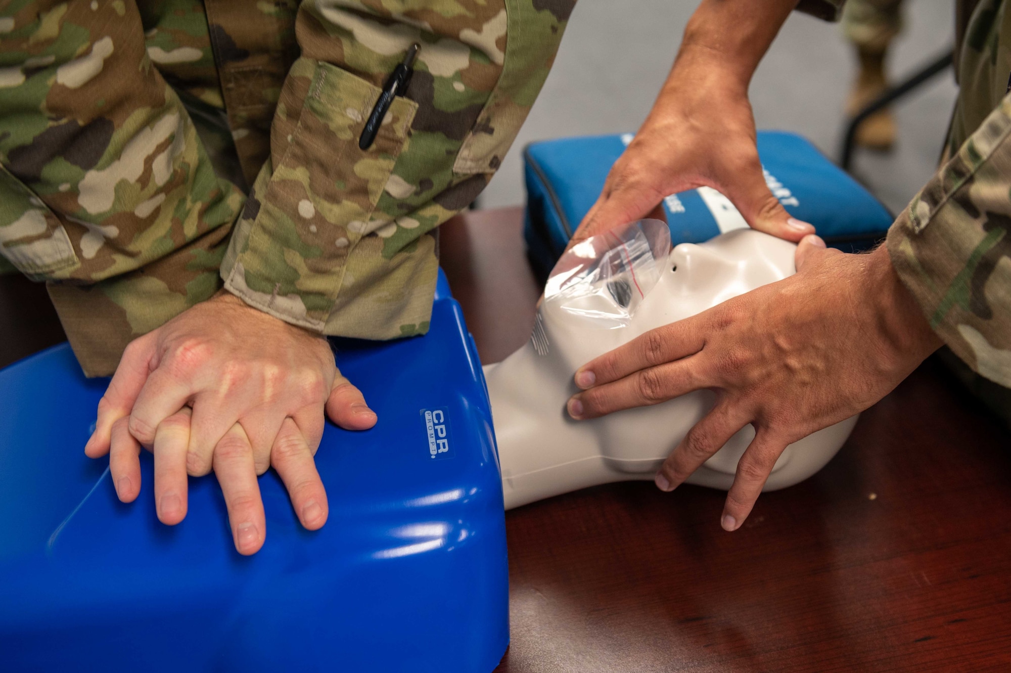 Staff Sgt. Joseph Gimino, right, 4th Security Forces Squadron patrolman, and Staff Sgt. Will Thompson, 4th SFS military working dog handler, perform chest compressions on a mannequin during a CPR class at Seymour Johnson, North Carolina, Nov. 9, 2021. Chest compressions are performed at a rate of 100 to 120 beats per minute. (U.S. Air Force photo by Airman 1st Class Sabrina Fuller)