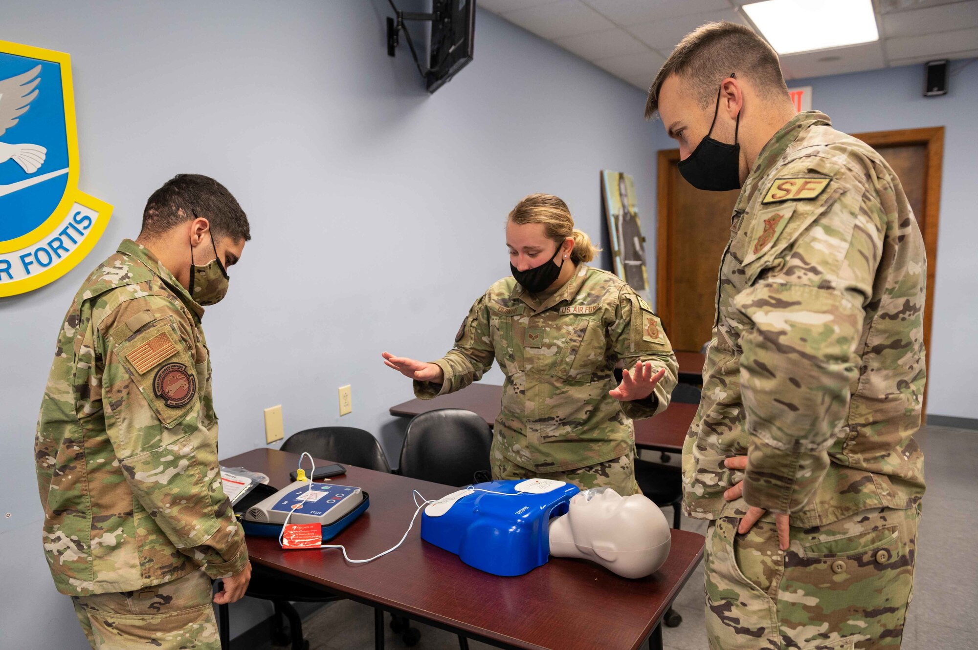 4th Security Forces Squadron members practice utilizing an automated external defibrillator on a mannequin during a CPR class at Seymour Johnson, North Carolina, Nov. 9, 2021. An AED is used to check a subject heart rhythm and send shocks to restore the heart to a normal heart rate. (U.S. Air Force photo by Airmen 1st Class Sabrina Fuller.)
