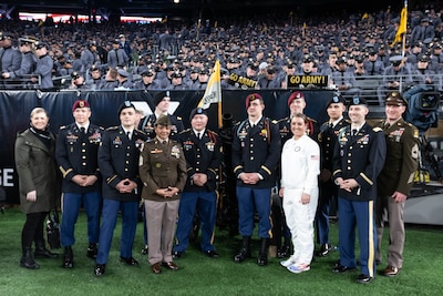 Spc. Jared Reyes, third from the left, is shown with other Soldiers honored at the Army-Navy game Dec. 11.