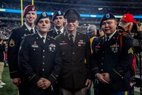 Spc. Jared Reyes, front left, of Harvard, Illinois, is shown with Sergeant Major of the Army Michael Grinston and other Soldiers honored at the Army-Navy game Dec. 11.