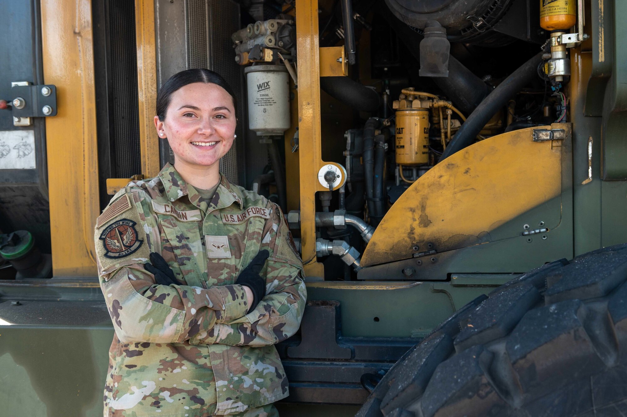 Airman Jasmine Cardin, 4th Logistics Readiness Squadron ground transportation vehicle operator, poses in front of a 10K All Terrain forklift at Seymour Johnson Air Force Base, North Carolina Dec. 3, 2021. The 4th LRS is one of the 4th Mission Support Group’s most diverse squadrons with more than 375 Airmen and civilians in eight Air Force Specialty Codes. (U.S. Air Force photo by Airman 1st Class Sabrina Fuller)