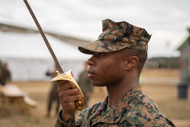 A Marine Combat Engineer sets off a satchel charge that blasts a