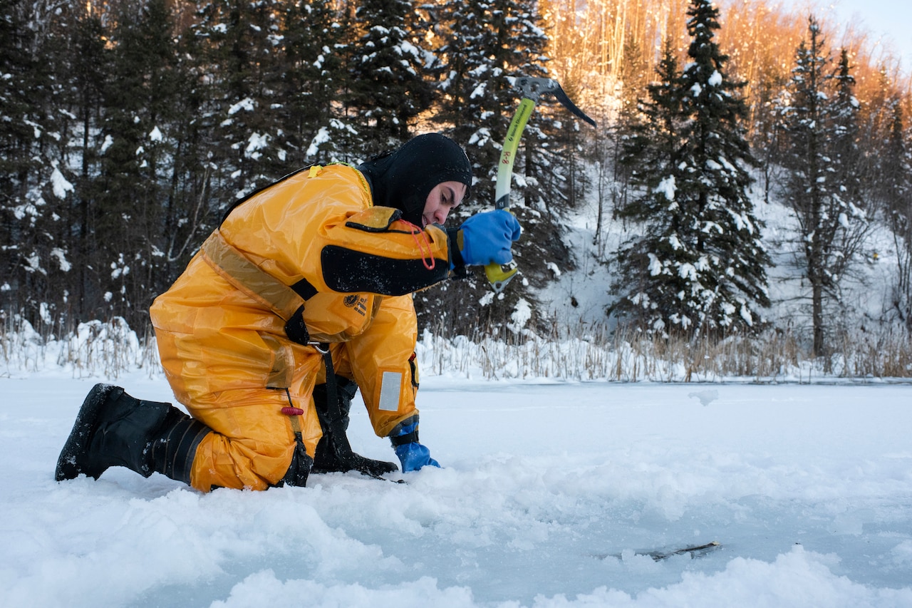 An airman uses an ice axe.