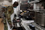 Senior Airman John Hiki of the 157th Maintenance Group reviews a food order Jan. 6, 2022, at Exeter Hospital in Exeter, New Hampshire.