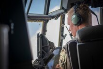 U.S. Air Force Capt. Jordan Webb, an AC-130J Ghostrider pilot assigned to the 4th Special Operations Squadron, looks out the window as a 105mm cannon is fired from an AC-130J Ghostrider, Eglin Range Complex, Florida, March 31, 2021. The 492nd Special Operations Training Group is the Air Force Special Operations Command's formal school for the AC-130J Ghostrider and MC-130H Talon II. They are responsible for assessing, educating and professionally developing SOF Airmen and rapidly developing innovative courses and technologies to meet emerging AFSOC requirements. (U.S. Air Force photo by Tech. Sgt. Michelle Di Ciolli)