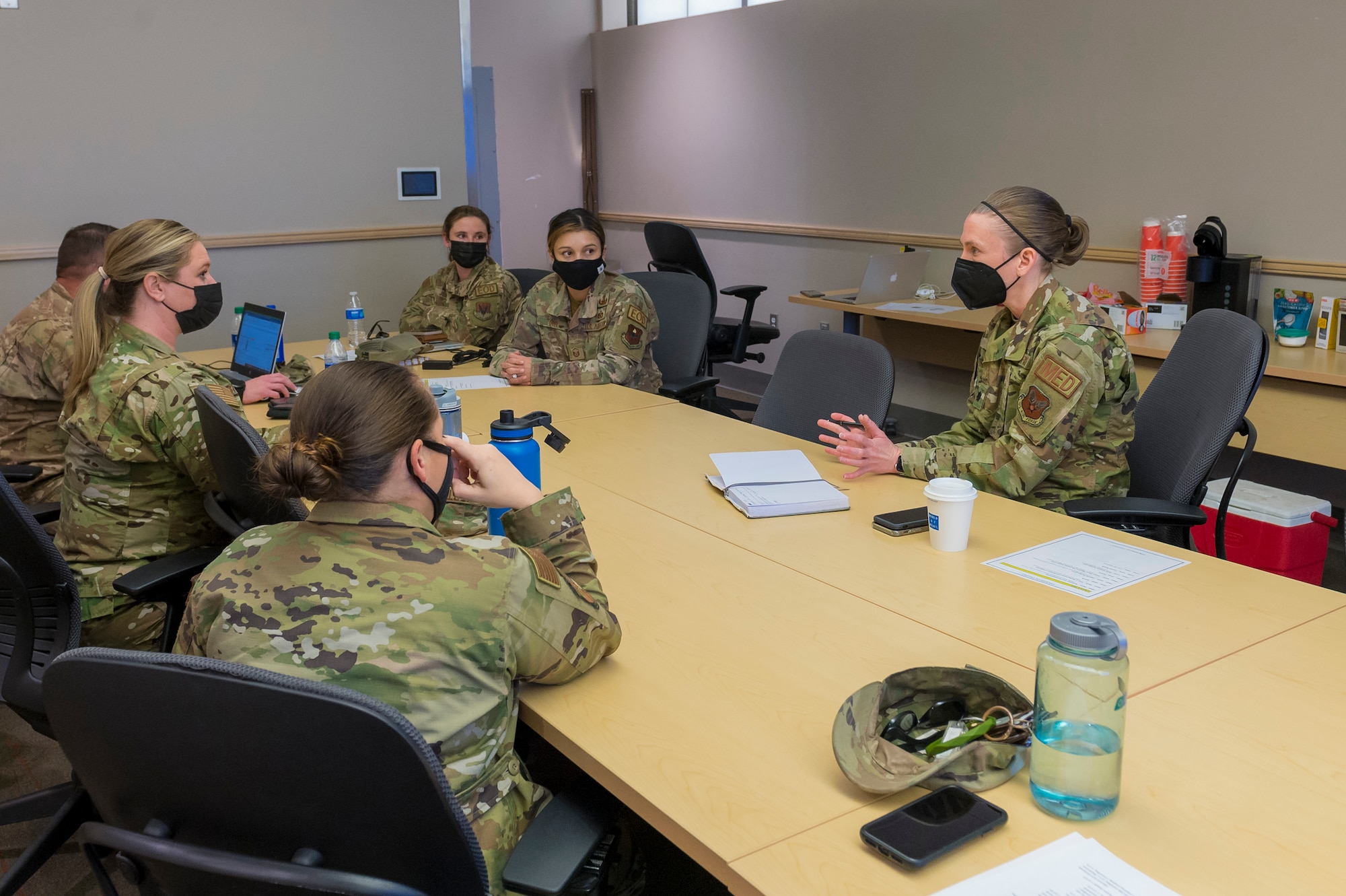 Lt. Col. Larissa Weir, Air Force Surgeon General’s chief women’s health consultant, right, meets with Air Force Explosive Ordnance Disposal Airmen to discuss postpartum policy recommendations for the career field's proposed Tier 2 physical fitness test, Joint Base San Antonio-Lackland, Texas, Jan. 6, 2022. The Air Force Installation and Mission Support Center invited female EOD Airmen from around the enterprise to take part in a working group to ensure mother’s needs are taken into account, while still keeping to the higher standard for the career field’s physical demands. Course of action developed at the meeting will be written into the draft Tier 2 test policy and sent to Headquarters Air Force for approval. (U.S Air Force photo by Malcolm McClendon).