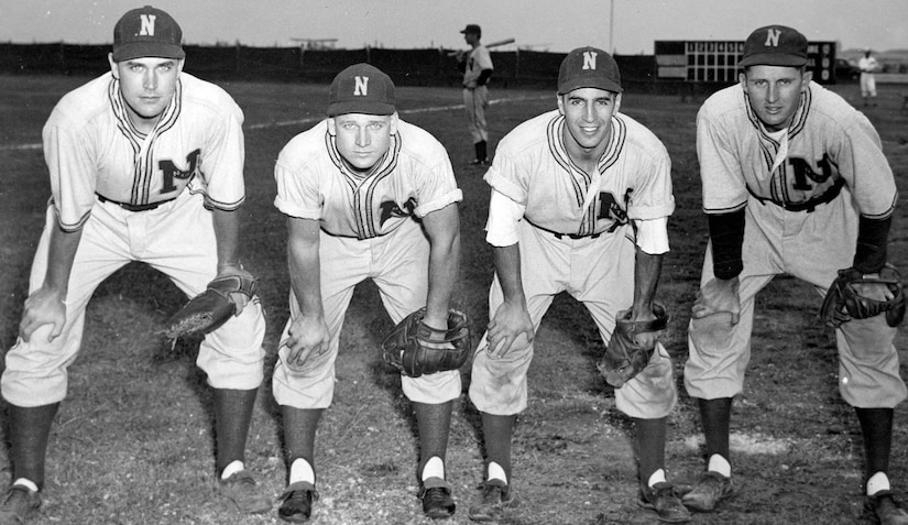 Four baseball players pose for a photo.