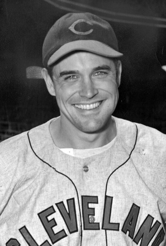 A baseball player poses for a photo.