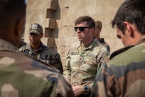 U.S. Army Staff Sgt. John Hampson, an instructor at the U.S. Army Mountain Warfare School, gives a block of instruction on mountain casualty evacuation to French service members with the 5th Overseas Interarms Regiment (5e RIAOM) at the French Combat Training Center at Arta Beach, Djibouti, Dec. 14, 2021. Five instructors from the U.S. Army Mountain Warfare School in Jericho, Vt. taught a five-day Joint Expeditionary Mountain Warfare Course on basic military mountaineering skills to French service members in Djibouti to strengthen the relationships among the international forces working together in the region. (U.S. Army Photo by Staff Sgt. Amanda Stock)