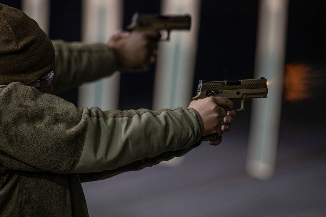 U.S. Air Force Master Sgt. Tamyka Spring, with the New Jersey Air National Guard's Joint Force Headquarters-Air, fires the new M18 modular handgun system during a qualification course at the Federal Air Marshal training center in Egg Harbor Township, N.J., Jan. 9, 2022.