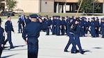 a flight of Air Force trainees marches by a one-star general