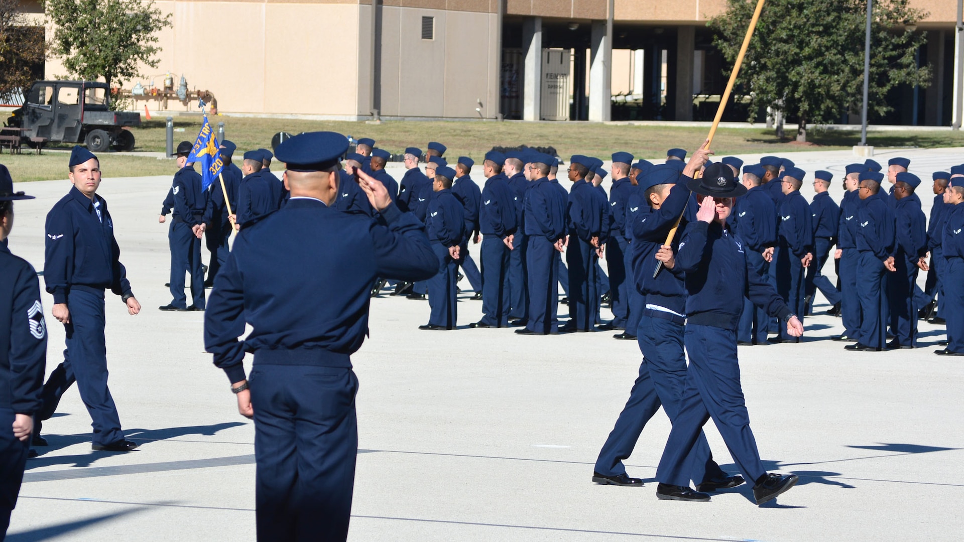 a flight of Air Force trainees marches by a one-star general