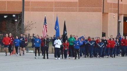 a large group of Air Force trainees running in formation