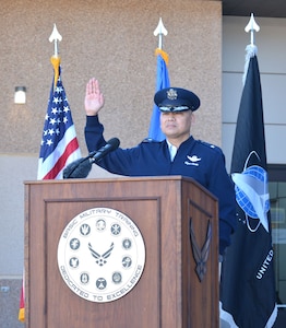 an Air Force one-star general raises his hand during Oath of Enlistment