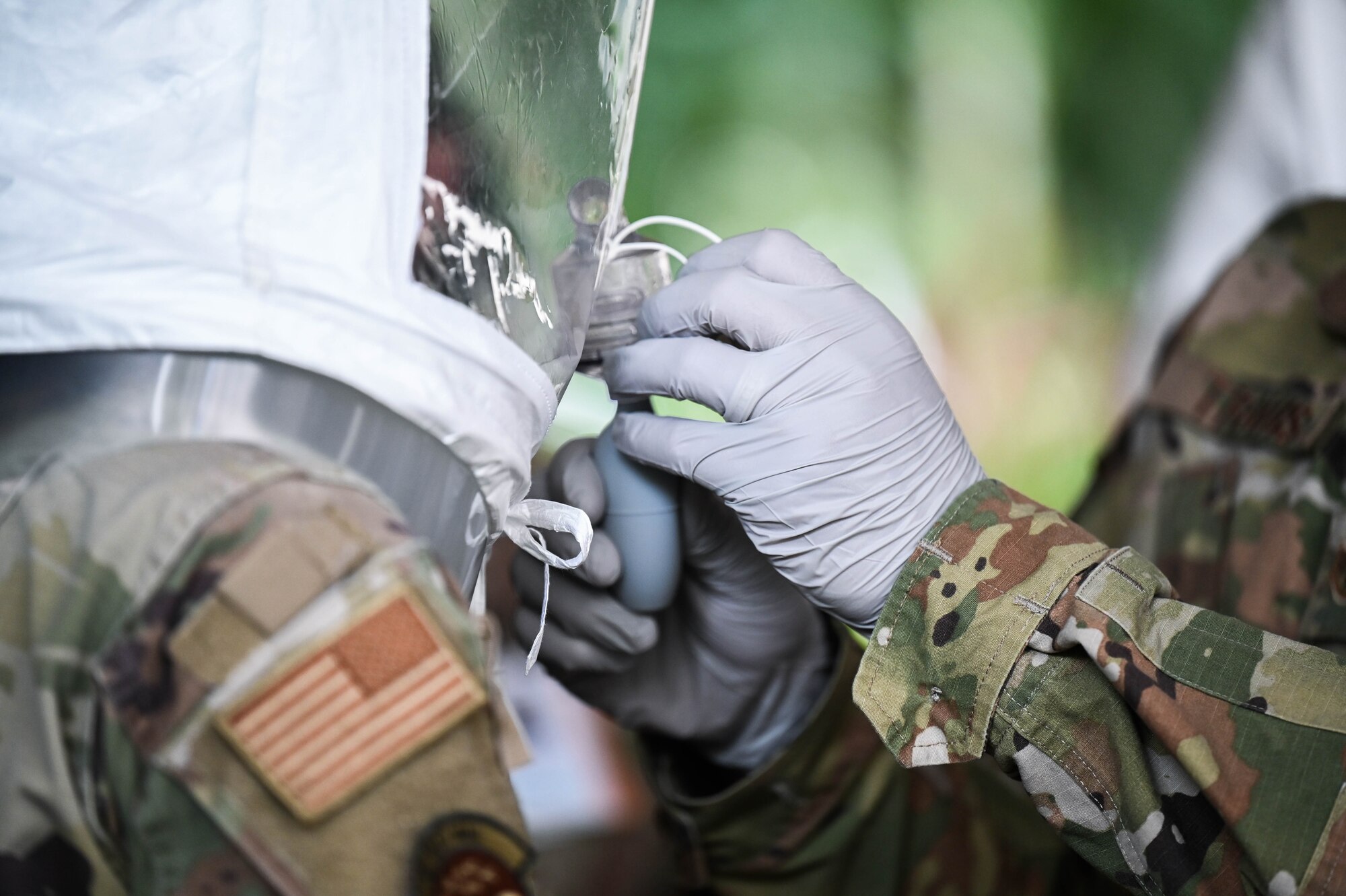15th Medical Group personnel are misted with a sensitivity solution during an N95 mask fit test at Joint Base Pearl Harbor-Hickam, Hawaii, Jan. 7, 2022. Testing was conducted to fit medical personnel with accurately fitted personal protective gear and to verify it’s effectiveness. (U.S. Air Force photo by Staff Sgt. Alan Ricker)