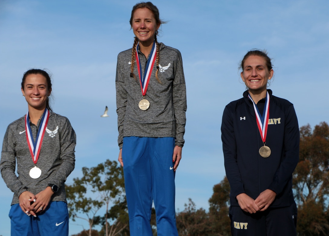 From left to right: Air Force 2nd lt. Maria Mettler of Kirtland AFB, N.M.; 1st Lt. Jaci Smith of Kirtland AFB, N.M.; and Navy Lt Cmdr. Katherine Irgens of Naval Submarine Base, New London, Conn. on the women's podium of the 2022 Armed Forces Cross Country Championship held in conjunction with the USA Track and Field National Cross Country Championship at Mission Bay Park in San Diego, Calif. on January 8th.  Runners from the Marine Corps, Navy (with Coast Guard) and Air Force compete for gold.  (Department of Defense Photo - Released)