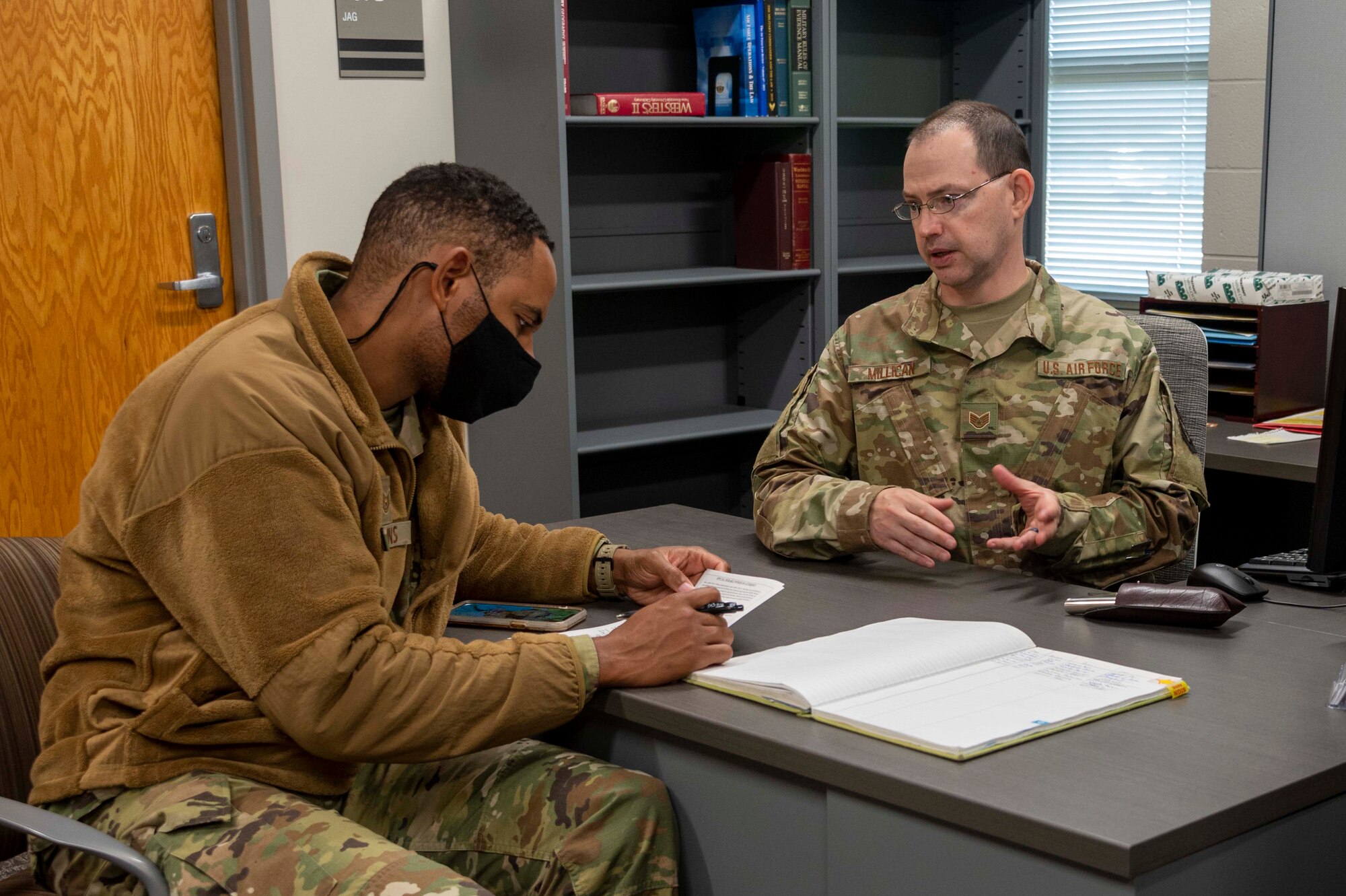 Photo of Airmen working at desk