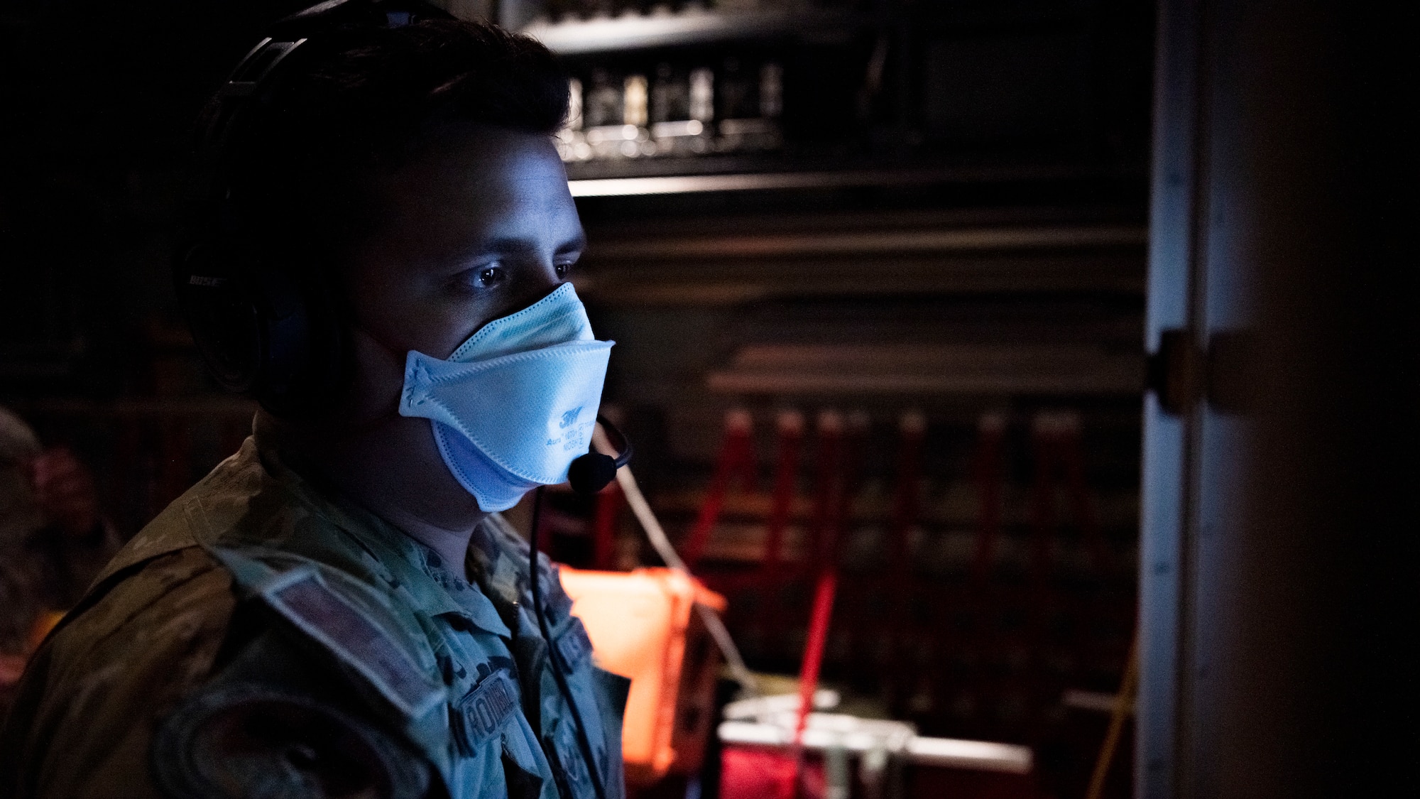 Airman looking at a piece of equipment.