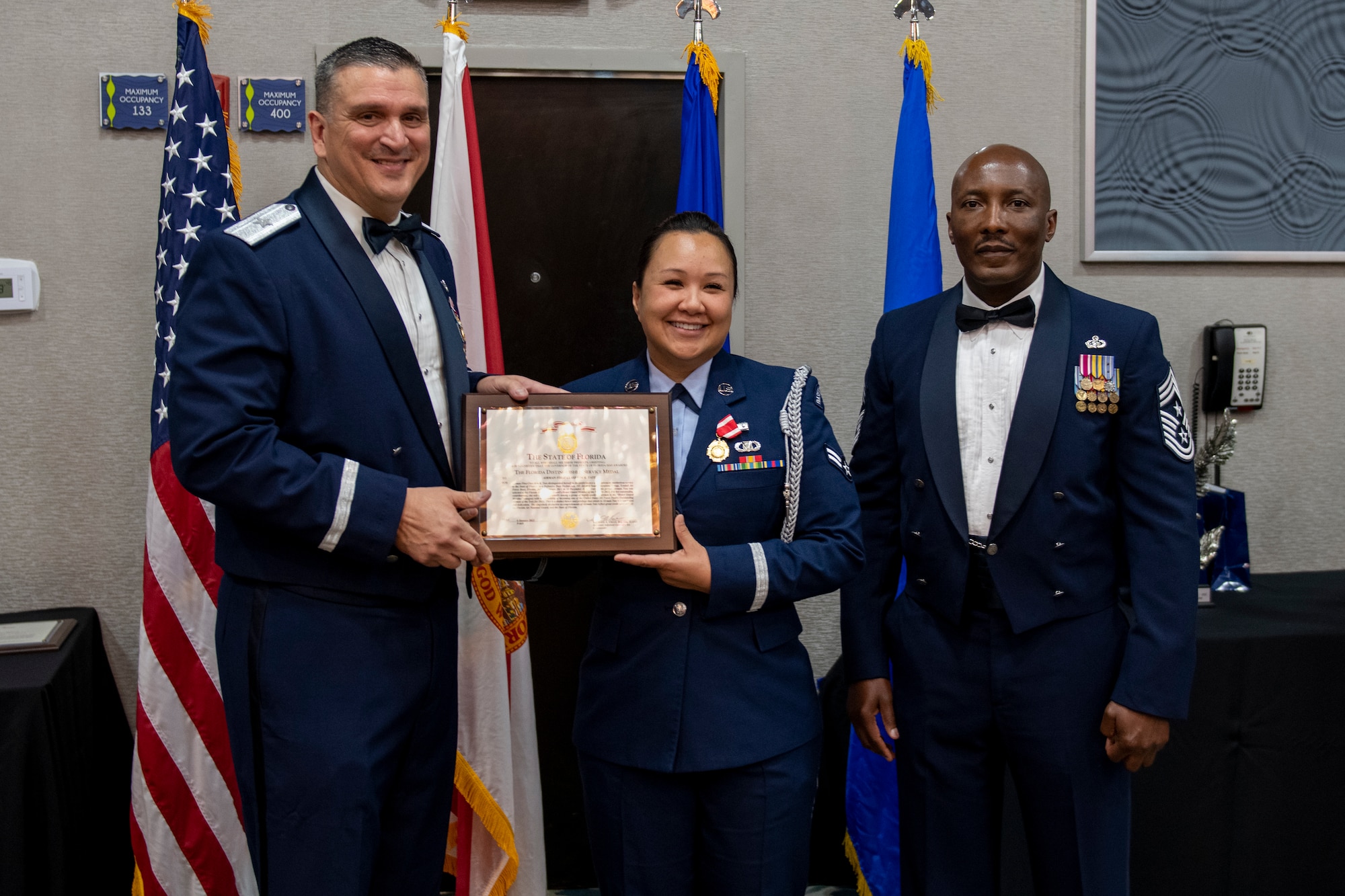 Airman 1st Class Kim Tate receives the Florida Distinguished Service Medal at the Florida Air National Guard's Airman of the Year banquet held in Jacksonville, Fla. on January 8, 2022. Tate holds the title of Airman of the Year for the Honor Guard Member category this year. The Airman of the Year award program is designed to recognize Airmen who display superior leadership, job performance and personal achievement during the prior calendar year. (U.S. Air National Guard photo by Senior Airman Jacob Hancock)