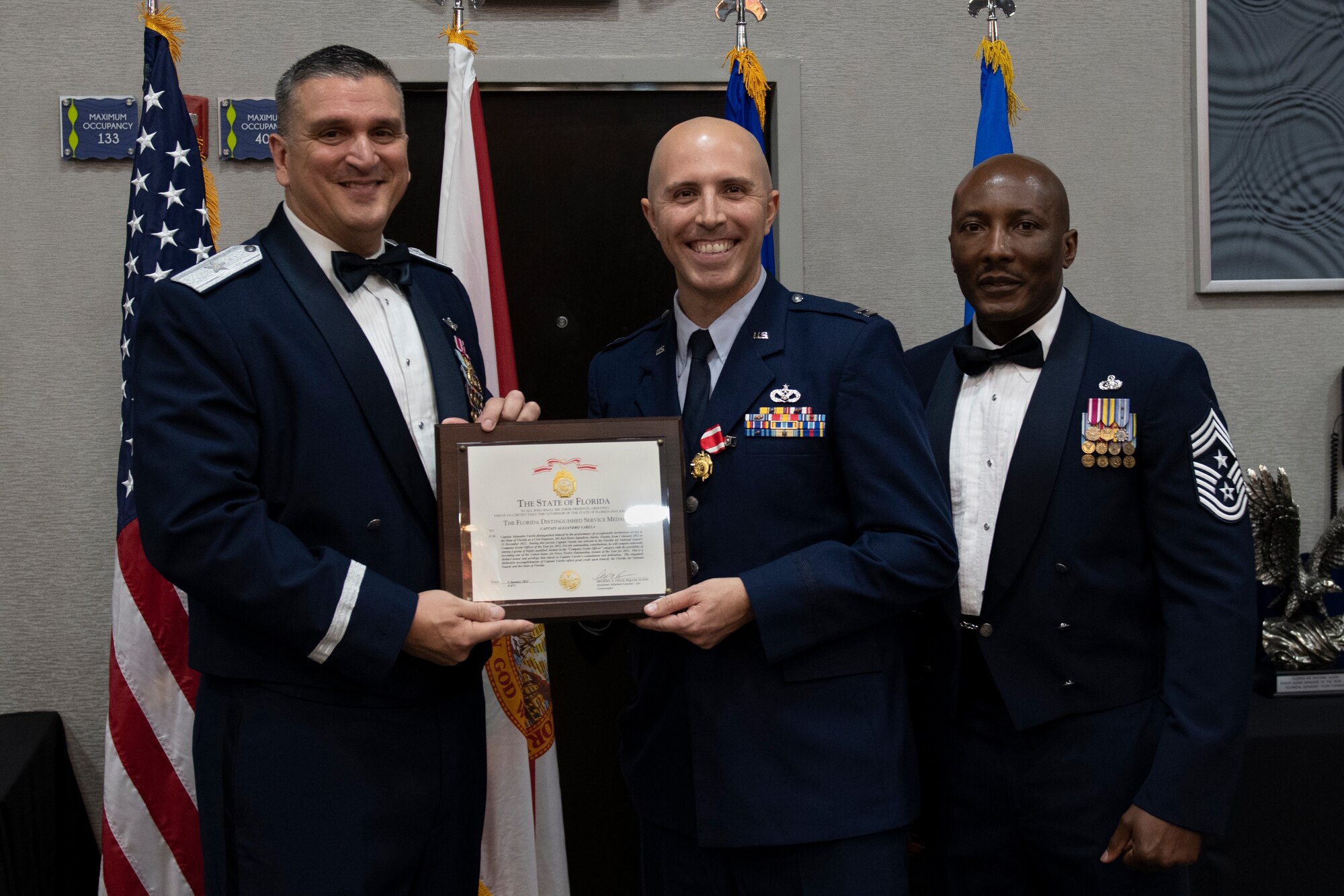 U.S. Air Force Capt. Alejandro Varela receives the Florida Distinguished Service Medal at the Florida Air National Guard's Airman of the Year banquet held in Jacksonville, Fla. on January 8, 2022. Varela holds the title of Airman of the Year for the Company Grade Officer category this year. The Airman of the Year award program is designed to recognize Airmen who display superior leadership, job performance and personal achievement during the prior calendar year. (U.S. Air National Guard photo by Senior Airman Jacob Hancock)
