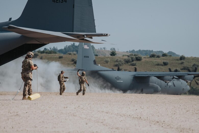 Airmen from the Kentucky Air National Guard’s 123rd Contingency Response Group prepare to perform an engine-running offload from a C-130 Hercules during a large-scale exercise in Logan, W.Va.., on July 22, 2021. The training took place during a week-long exercise named Sentry Storm 2021 that featured multiple units from the Air and Army National Guard, U.S. Air Force, Air Force Reserve, U.S. Navy and Civil Air Patrol. (U.S. Air National Guard photo by Staff Sgt. Vincent Santos)
