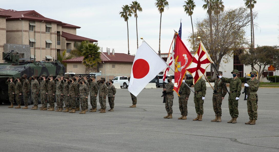 U.S. Marines with the 15th Marine Expeditionary Unit and Japan Ground Self-Defense Force (JGSDF) soldiers with 2nd Amphibious Rapid Deployment Regiment render honors during the Japanese and United States national anthems as part of the Exercise Iron Fist 2022 opening ceremony at Marine Corps Base Camp Pendleton, California, Jan. 10, 2022. Iron Fist is a bilateral exercise that demonstrates the interoperability between the U.S. Marine Corps and JGSDF. (U.S. Marine Corps photo by Cpl. Carl Matthew Ruppert)