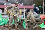 Members of the Washington National Guard respond to flooding Jan. 7, 2022, in Lewis County, Wash. The Guard members filled sandbags and provided other support.