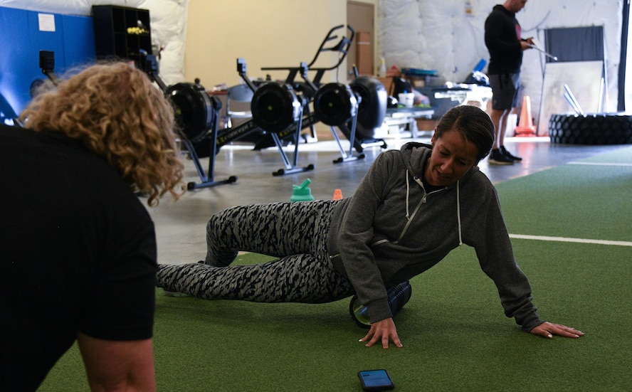 Photo of Airman using a foam roller
