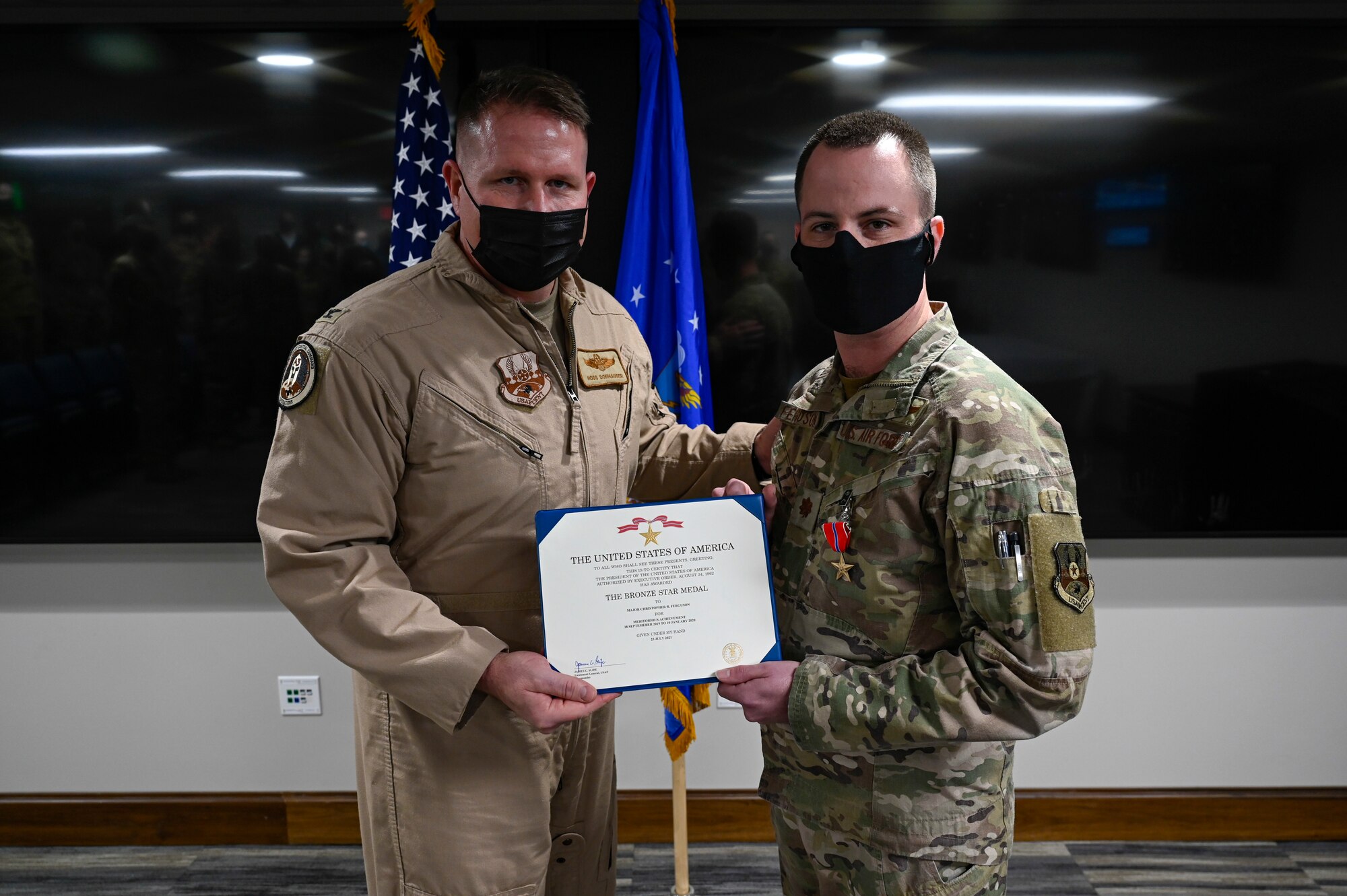 A photo of two airmen posing for a photo