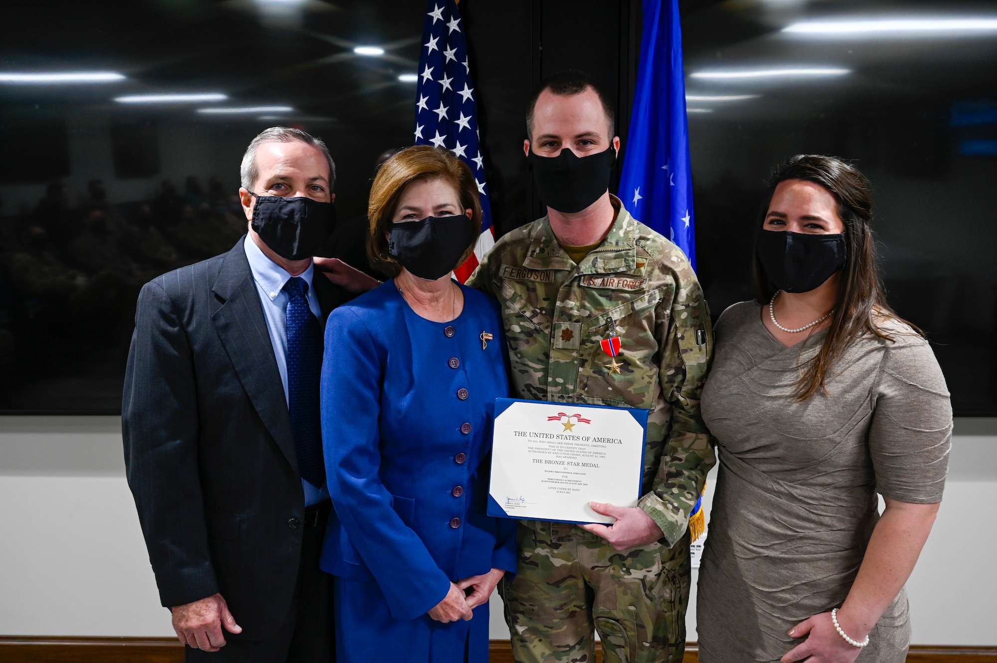 A photo of an airmen and his family