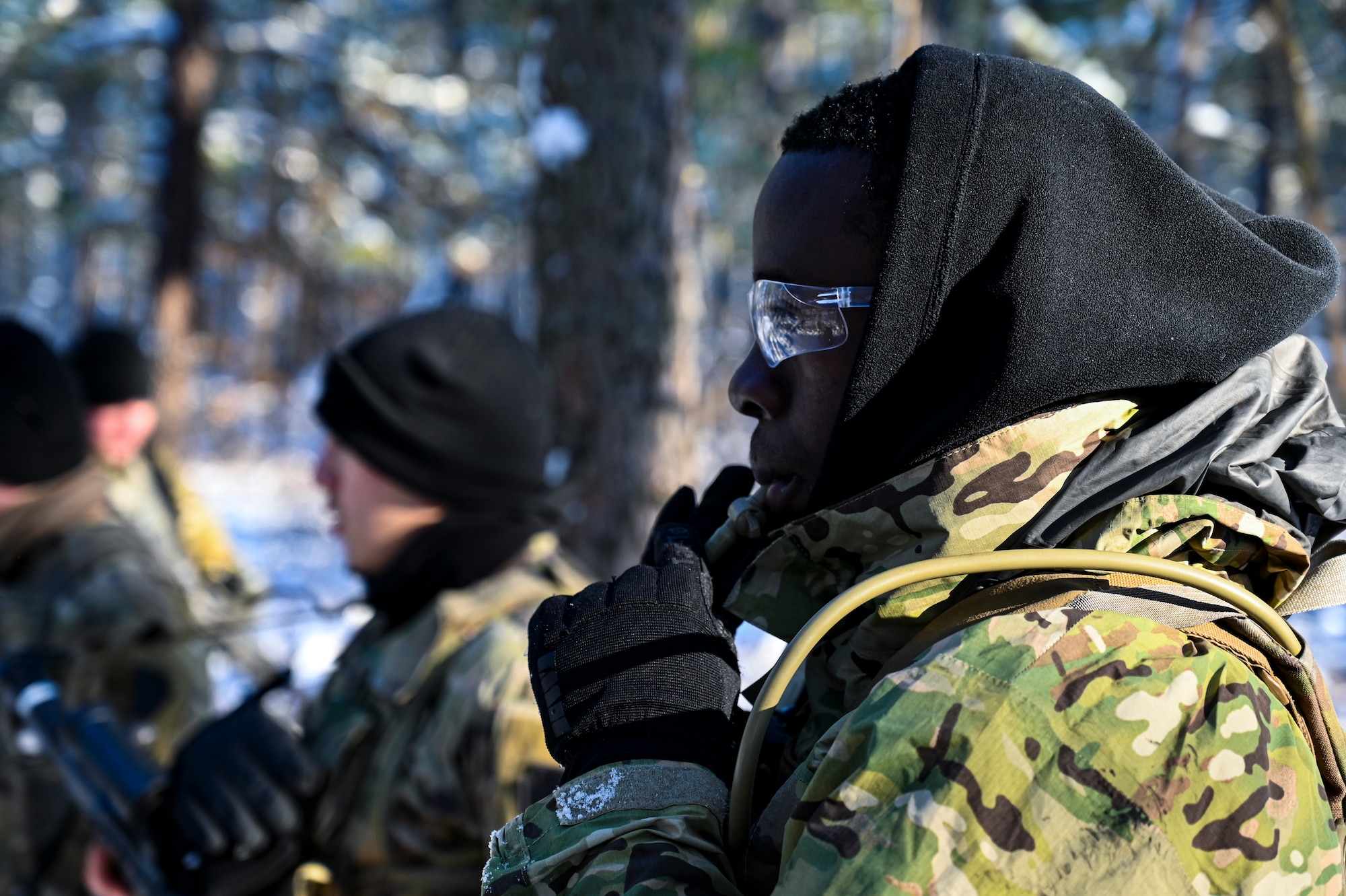 U.S. Army Pfc. Nahan Sogoti, Third Platoon, Blackfoot Company, 111th Infantry Regiment, Infantryman, poses for a photo while hydrating on Jan. 7, 2022, at Joint Base McGuire-Dix-Lakehurst, N.J. Using a training range on Army Support Activity Dix, Soldiers conducted Situational Training Exercise Lanes (STX Lanes) and other contact drill training exercises to enhance combat readiness. STX Lanes are designed to simulate a search and attack before initial contact is made with the enemy, where moving undetected is critical to a favorable engagement. The 111th Infantry Regiment has Colonial roots in the American Revolution and was founded by Benjamin Franklin on Nov. 21, 1747. It is Pennsylvania’s oldest regiment and often assisted George Washington and the Continental Army alongside the Delaware River.