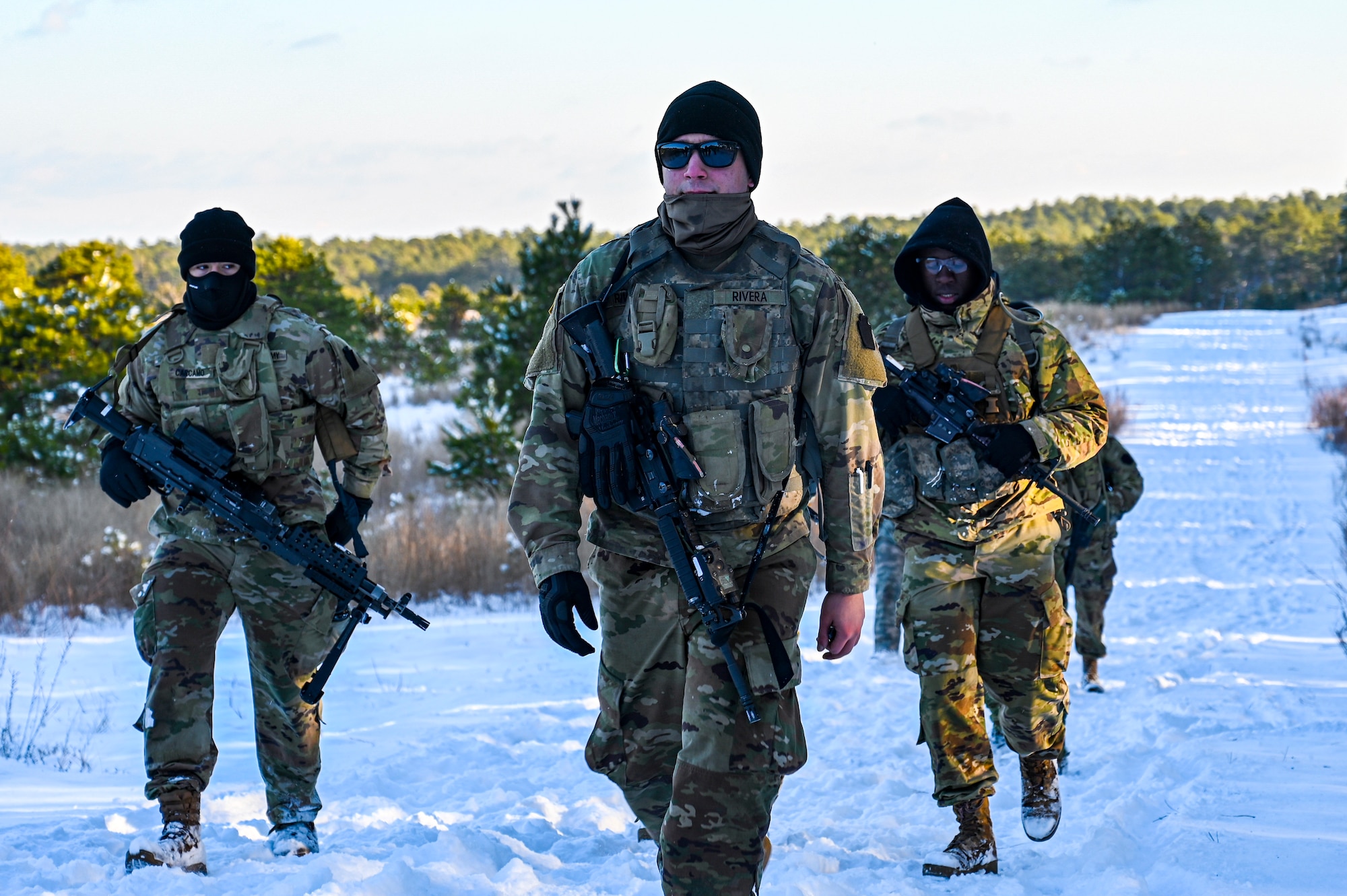 U.S. Army Pvt. Jason Rivera (Center), U.S. Army Spc. Anthony Carcamo (Left), U.S. Army Pfc. Nathan Sogoti (Right), Third Platoon, Blackfoot Company, 111th Infantry Regiment, Infantrymen, pose for a photo with M4 carbine assault rifles and an M240B machine gun while returning staging area on Jan. 7, 2022, at Joint Base McGuire-Dix-Lakehurst, N.J. Using a training range on Army Support Activity Dix, Soldiers conducted Situational Training Exercise Lanes (STX Lanes) and other contact drill training exercises to enhance combat readiness. STX Lanes are designed to simulate a search and attack before initial contact is made with the enemy, where moving undetected is critical to a favorable engagement. The 111th Infantry Regiment has Colonial roots in the American Revolution and was founded by Benjamin Franklin on Nov. 21, 1747. It is Pennsylvania’s oldest regiment and often assisted George Washington and the Continental Army alongside the Delaware River.
