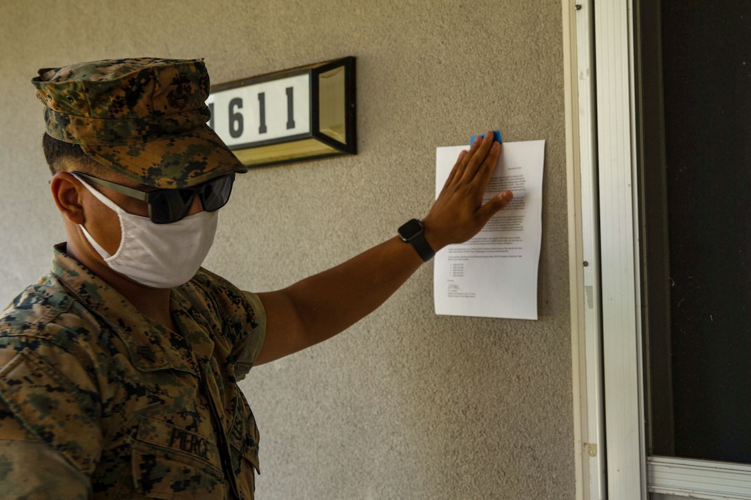 U.S. Marine Corps Sgt. Donald B. Pierce, transmission supervisor, 3rd Marine Regiment, 3rd Marine Division, posts a notification letter to a military resident’s house in Pearl City, Hawaii, Dec. 26, 2021. As part of Task Force KULEANA, Marines passed out letters to military residents affected by the water contamination at Red Hill to provide an update on the efforts to restore clean water to the surrounding communities. (U.S. Marine Corps photo by Lance Cpl. Haley Fourmet Gustavsen)