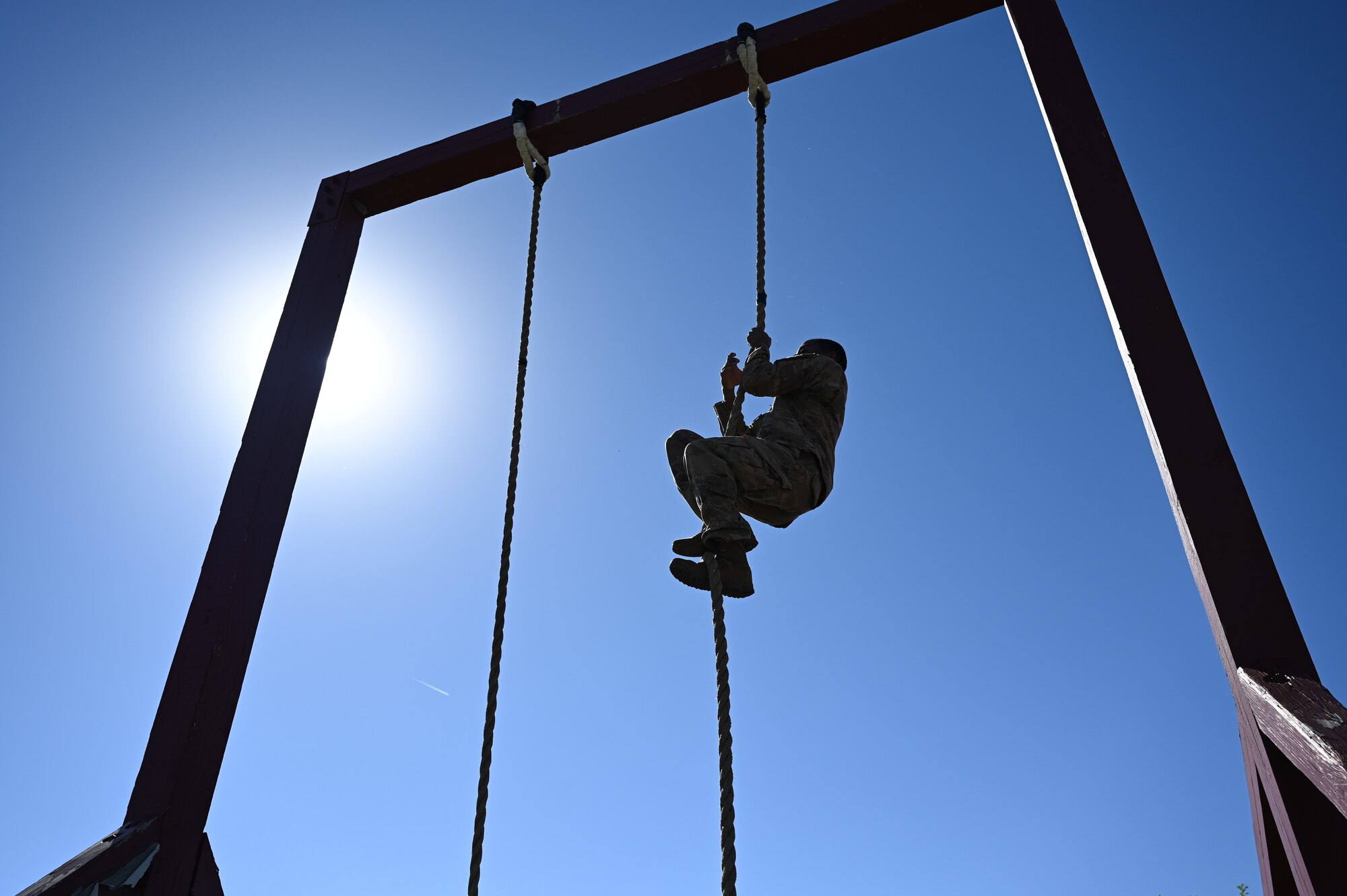 person climbing down rope