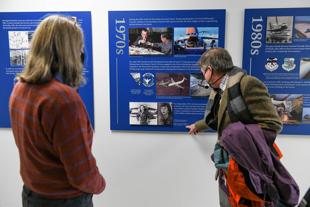 U.S. Air Force Lt. Gen. (Ret.) Michelle Johnson and her husband, John Hargreaves, admire the new 97th Training Squadron heritage wall on Altus Air Force Base, Oklahoma, Jan. 7, 2022. The wall showcases a timeline of significant points throughout history that lead to the TRS of today. (U.S. Air Force photo by Airman 1st Class Trenton Jancze)