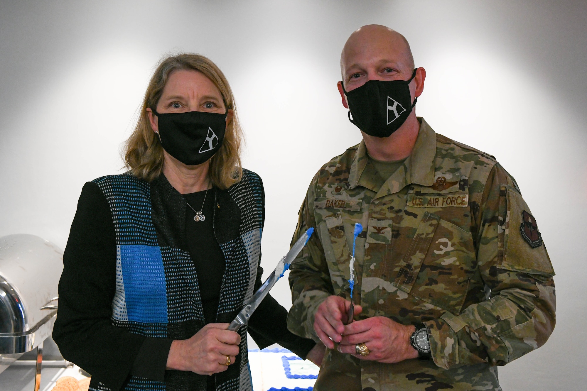 U.S. Air Force Lt. Gen. (Ret.) Michelle Johnson and Col. Blaine Baker, 97th Air Mobility Wing commander, pose for a photo after cutting the anniversary cake on Altus Air Force Base, Jan. 7, 2022. The cake cutting was in celebration of 97th Training Squadron’s 20th operational anniversary. (U.S. Air Force photo by Airman 1st Class Trenton Jancze)