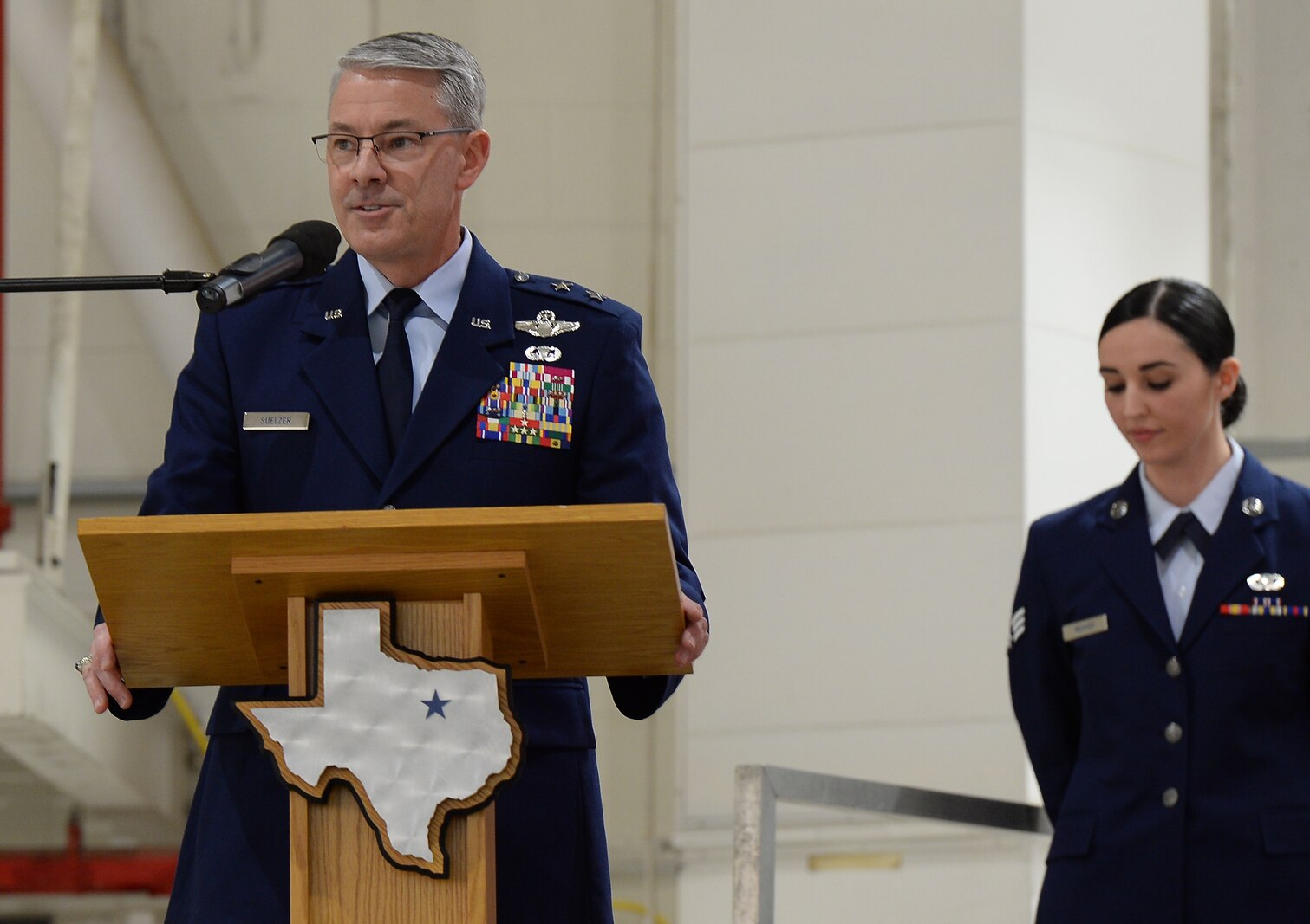 Maj Gen Suelzer articulates during the recent ceremonies as Senior Airmen Weaver stands by.