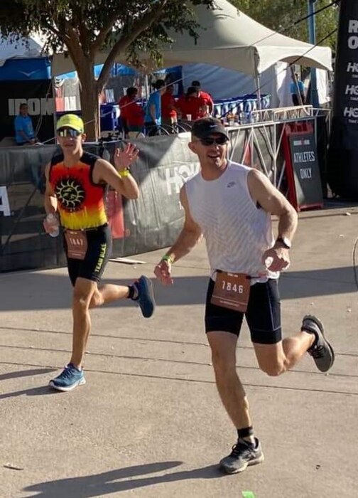 U.S. Air Force Col. Luke Casper, right, 56th Fighter Wing vice commander, and his friend, U.S. Air Force Maj. Miguel Fernandez, Air Force Academy admission liaison officer, participate in an Ironman Triathlon, Nov. 21, 2021, in Tempe, Arizona. Ironman Arizona challenges athletes to complete a 2.4-mile swim course, 112-mile bike course and a 26.2-mile run course. (Courtesy photo)