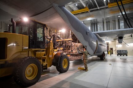 Alaska National Guard Soldiers and Airmen aboard an HC-130J Combat King II on Joint Base Elmendorf-Richardson Jan. 12, 2022, depart for the Southeast Alaska community of Yakutat. Guard members serving on Joint Task Force-Yakutat will provide building safety assessments and emergency snow removal for Tribal, public and government facilities in the community following hazardous winter weather and heavy snowfall resulting in building damage and continued risk of unsafe conditions. Yakutat is in the Tongass National Forest, the largest National Forest in the U.S. and home to the largest population of bald eagles in the world. The Alaska National Guard is trained, equipped and ready to provide disaster response support for the State of Alaska when requested by civil authorities. (U.S. Army National Guard photo by Spc. Grace Nechanicky)