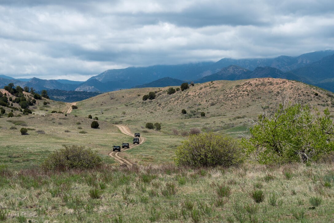 Four Humvees driven by members of the Kentucky Air National Guard’s 123rd Security Forces Squadron execute convoy operations during field training at Fort Carson, Colo., May 19, 2021. More than 30 Airmen from the unit travelled here to strengthen their specialized skills during nine days of field exercises at several different ranges. (U.S. Air National Guard photo by Phil Speck)