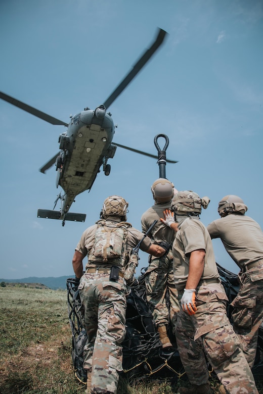 Airmen from the Kentucky Air National Guard’s 123rd Contingency Response Group prepare to hook a sling load to a U.S. Navy MH-60S Seahawk during a large-scale exercise in Logan, W.Va.., on July 20, 2021. The training took place during a week-long exercise named Sentry Storm 2021 that included multiple units including Air and Army National Guard, U.S. Air Force, Air Force Reserve, U.S. Navy, and Civil Air Patrol. U.S. Air National Guard photo by Staff Sgt. Vincent Santos)