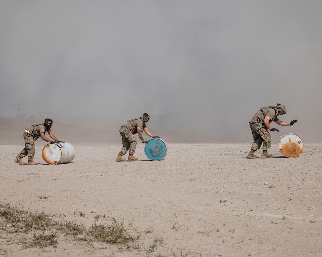 Airmen from the Kentucky Air National Guard’s 123rd Contingency Response Group roll out barrels to perform a “Method B” engine-running offload from a C-130 Hercules during a large-scale exercise in Logan, W.Va.., on July 22, 2021. The training took place during a week-long exercise named Sentry Storm 2021 that featured multiple units from the Air and Army National Guard, U.S. Air Force, Air Force Reserve, U.S. Navy and Civil Air Patrol. (U.S. Air National Guard photo by Staff Sgt. Vincent Santos)