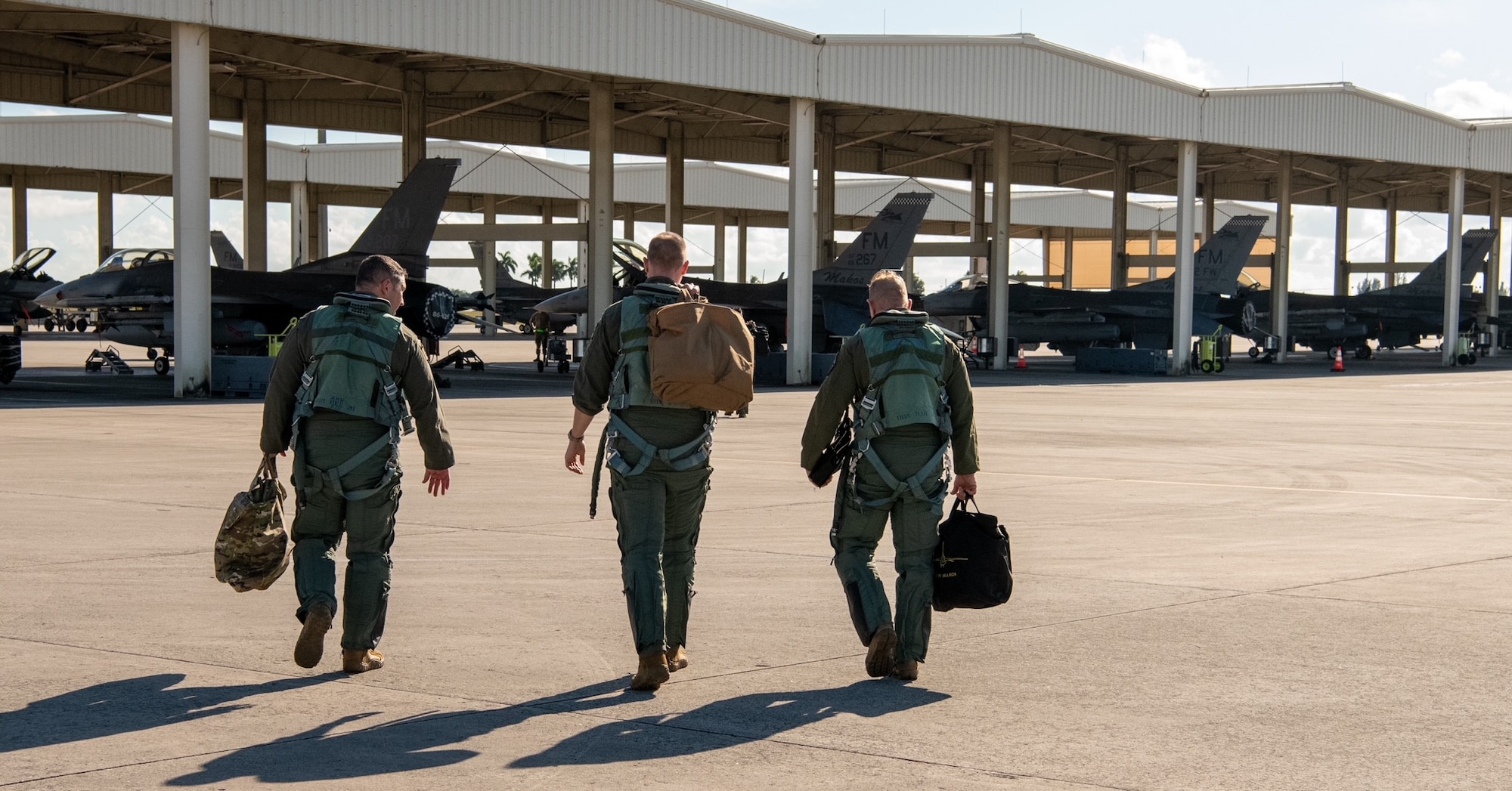 Lt. Col. Joseph “Hooter” Feheley, right, steps out to his aircraft to perform his final flight on his retirement day at Homestead Air Reserve Base, Florida, Dec. 10, 2021. (U.S. Air Force photo by Master Sgt. Allissa Landgraff)