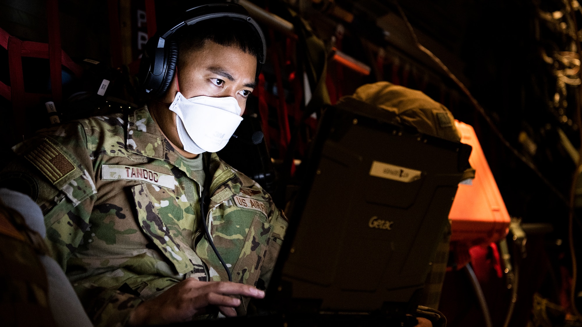 Airman typing on a computer