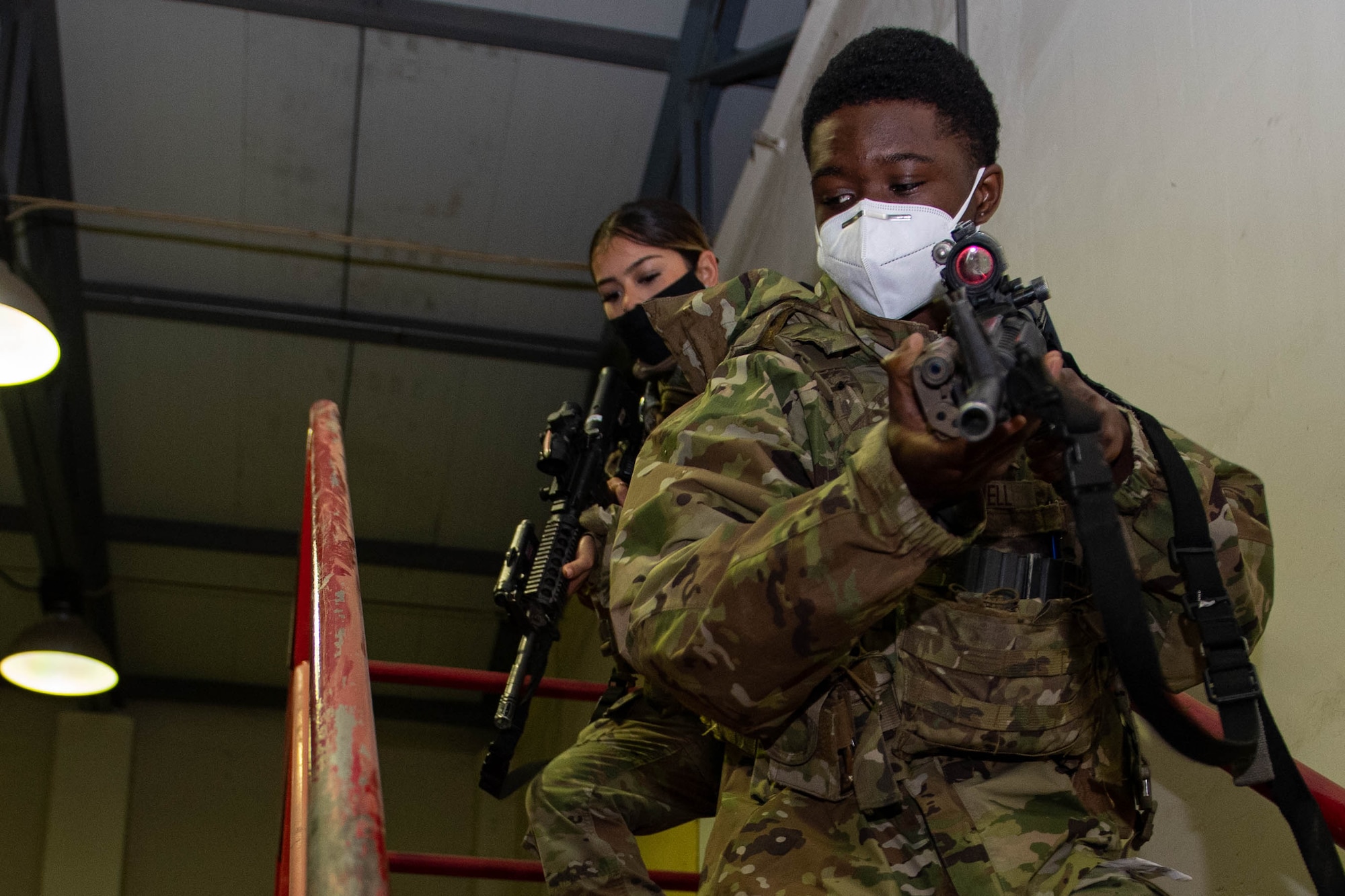 Two security forces Airmen practice tactical team movements