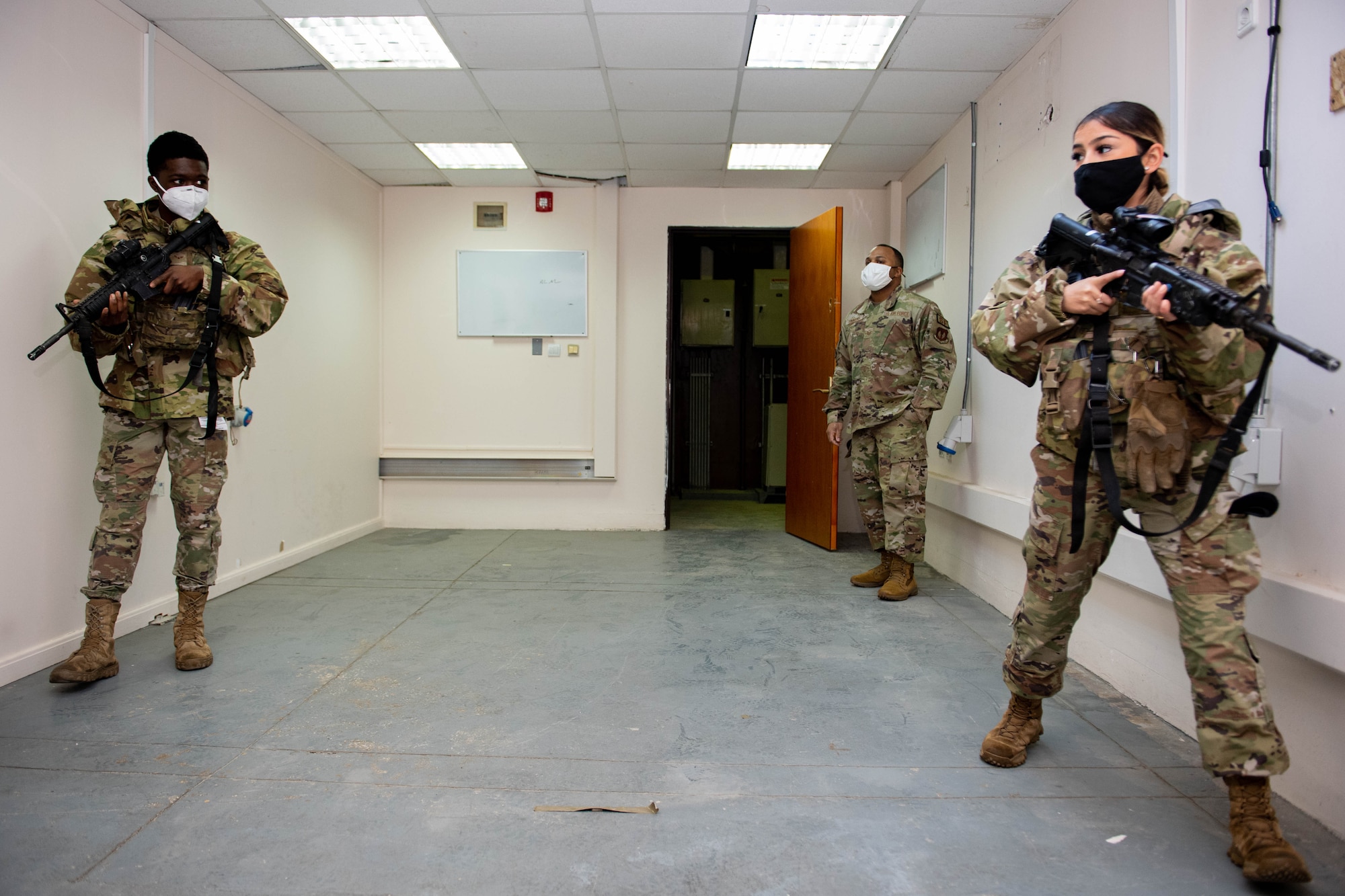 Two security forces Airmen practice room clearing tactics